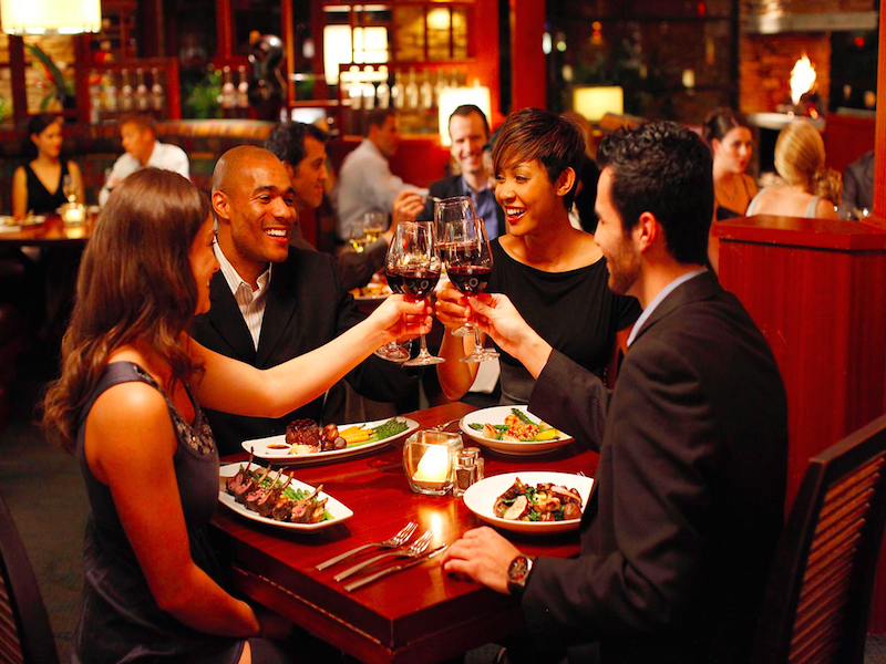 Two couples enjoying a meal in a restaurant
