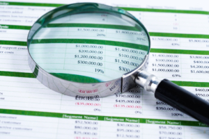 Forensic Accounting Spreadsheet and magnifying glass